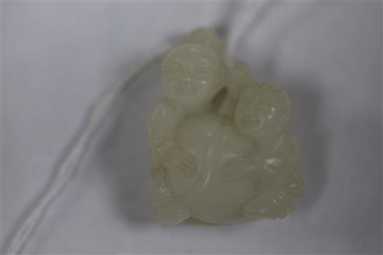 A Chinese white jade two boys carving and a celadon jade lion-dog, H. 3.7cm and 4.4cm